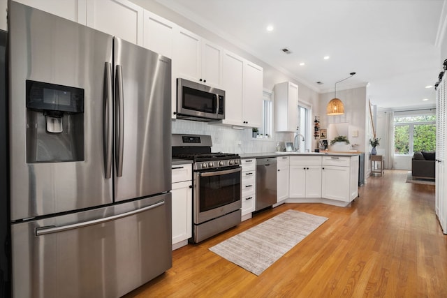 3316 N Leavitt St Unit 2, Chicago, IL 60618 - kitchen with appliances with stainless steel finishes, light wood-type flooring, white cabinetry, tasteful backsplash, and ornamental molding