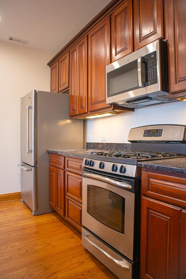5064 W Agatite Ave Unit 3, Chicago, IL 60630 - kitchen with appliances with stainless steel finishes, light wood-type flooring, and brown cabinetry