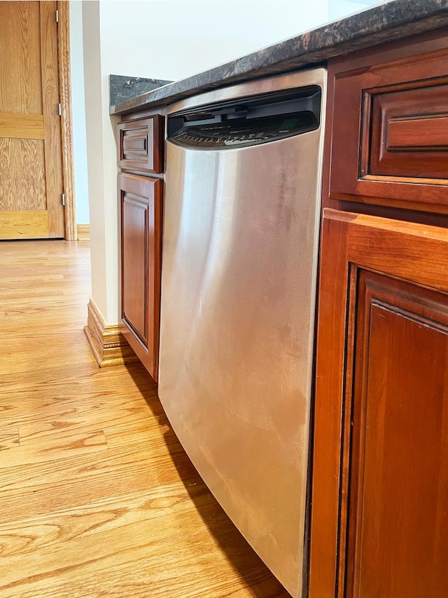 5064 W Agatite Ave Unit 3, Chicago, IL 60630 - kitchen view of stainless steel dishwasher, light wood-style floors, and dark countertops