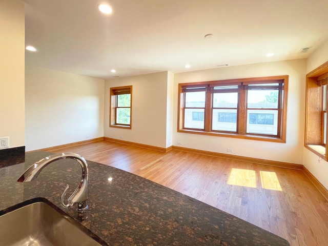 5064 W Agatite Ave Unit 3, Chicago, IL 60630 - kitchen with wood finished floors, dark stone counters, and recessed lighting