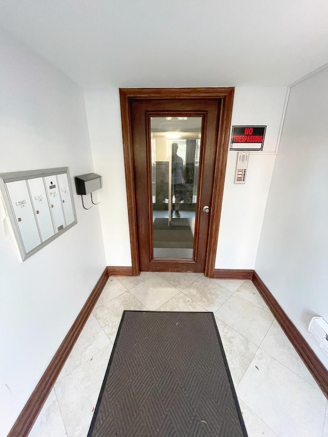 5064 W Agatite Ave Unit 3, Chicago, IL 60630 - corridor featuring baseboards and light tile patterned floors