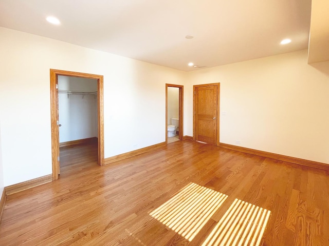 5064 W Agatite Ave Unit 3, Chicago, IL 60630 - unfurnished bedroom featuring a walk in closet, recessed lighting, light wood-style flooring, ensuite bath, and a closet