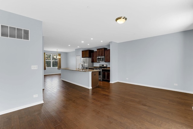 406 Prairie Ct, Morton Grove, IL 60053 - kitchen featuring stainless steel appliances, dark wood-type flooring, a center island with sink, dark brown cabinetry, and recessed lighting