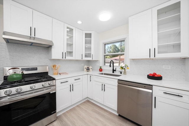 10846 S Sacramento Ave, Chicago, IL 60655 - kitchen with stainless steel appliances, exhaust hood, light wood finished floors, white cabinets, and backsplash