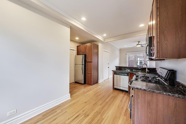 3851 N Kedvale Ave Unit E3, Chicago, IL 60641 - kitchen featuring stainless steel appliances, ornamental molding, light wood-style flooring, dark stone countertops, and recessed lighting