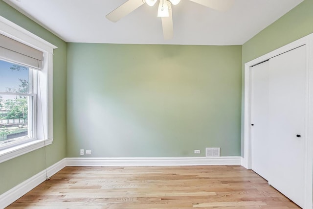 3851 N Kedvale Ave Unit E3, Chicago, IL 60641 - unfurnished bedroom with multiple windows, light wood-style floors, a closet, and ceiling fan
