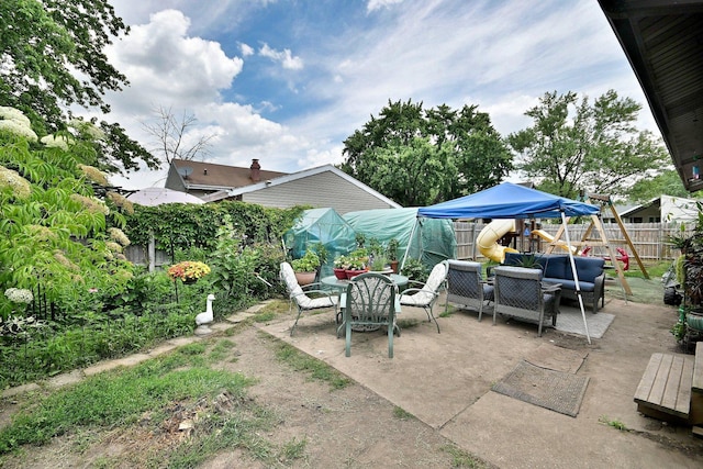 518 Emerson Cir, Bolingbrook, IL 60440 - fenced backyard featuring an outdoor hangout area, a patio, a playground, and outdoor dining area