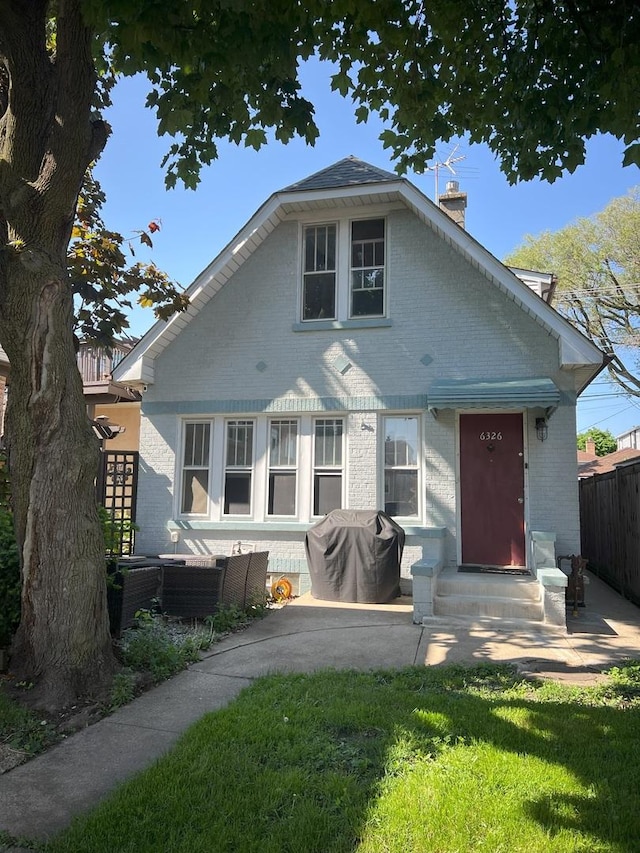 6326 W Berenice Ave, Chicago, IL 60634 - back of property featuring brick siding, a chimney, and entry steps