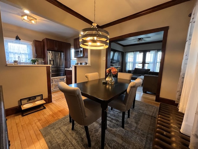6326 W Berenice Ave, Chicago, IL 60634 - dining room featuring ornamental molding, light wood-style floors, healthy amount of natural light, and a chandelier