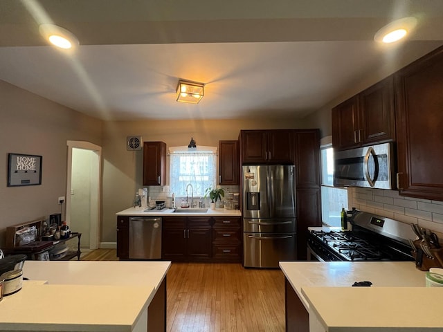6326 W Berenice Ave, Chicago, IL 60634 - kitchen featuring appliances with stainless steel finishes, light countertops, tasteful backsplash, and light wood-style flooring