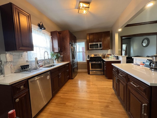 6326 W Berenice Ave, Chicago, IL 60634 - kitchen with appliances with stainless steel finishes, light wood-type flooring, decorative backsplash, and light countertops