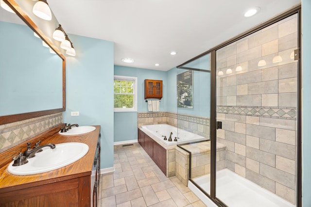 401 Greenwood Rd, Glenview, IL 60025 - full bath featuring a garden tub, double vanity, a shower stall, backsplash, and recessed lighting