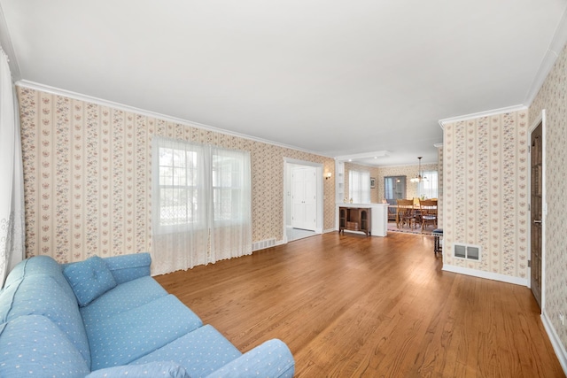 401 Greenwood Rd, Glenview, IL 60025 - living area featuring crown molding, wallpapered walls, and wood finished floors