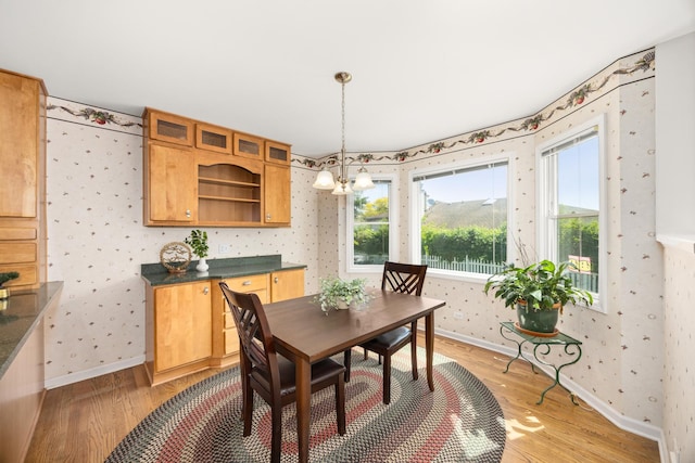 401 Greenwood Rd, Glenview, IL 60025 - dining room featuring wallpapered walls, light wood finished floors, and a chandelier