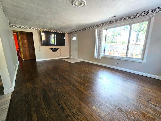 355 Oswego St, Park Forest, IL 60466 - unfurnished living room featuring wood finished floors and a textured ceiling