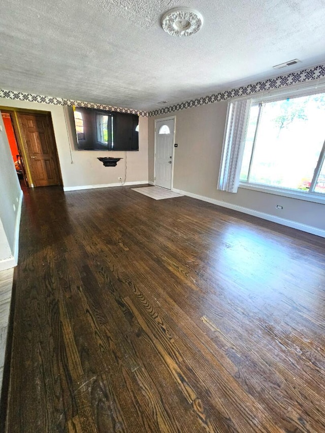 355 Oswego St, Park Forest, IL 60466 - unfurnished living room with a textured ceiling and wood finished floors