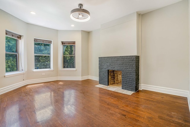 4640 N Kenmore Ave Unit 2S, Chicago, IL 60640 - unfurnished living room with wood finished floors, a brick fireplace, and recessed lighting