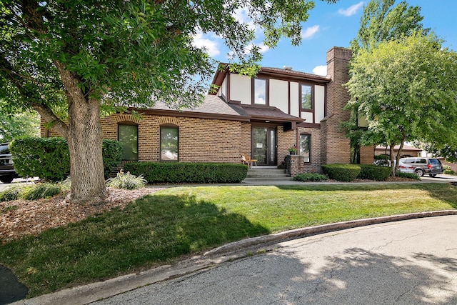 12256 S Arbor Trl Unit 11W, Palos Heights, IL 60463 - tudor home with a front yard, brick siding, and a chimney