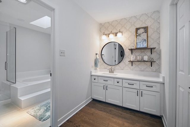 12256 S Arbor Trl Unit 11W, Palos Heights, IL 60463 - full bath featuring vanity, a bath, an accent wall, wood finished floors, and a skylight
