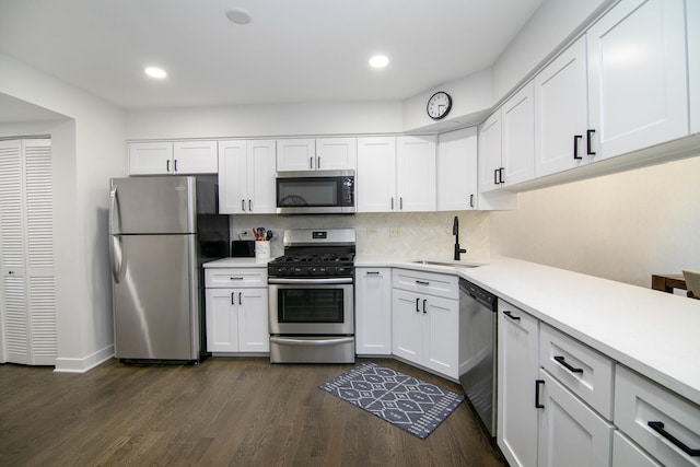 12256 S Arbor Trl Unit 11W, Palos Heights, IL 60463 - kitchen with appliances with stainless steel finishes, light countertops, white cabinetry, tasteful backsplash, and dark wood-style flooring