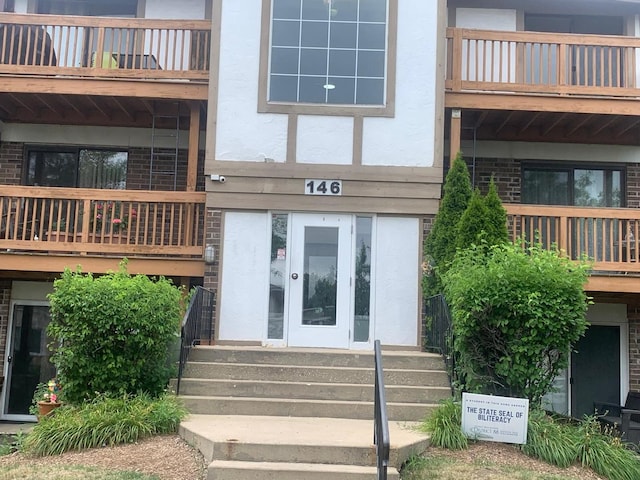 146 S Lalonde Ave Unit 3B, Addison, IL 60101 - view of exterior entry featuring a balcony, stucco siding, and brick siding