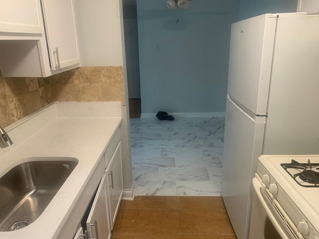 247 N Neltnor Blvd Unit E-1A, West Chicago, IL 60185 - kitchen with white cabinetry, marble finish flooring, light countertops, and freestanding refrigerator