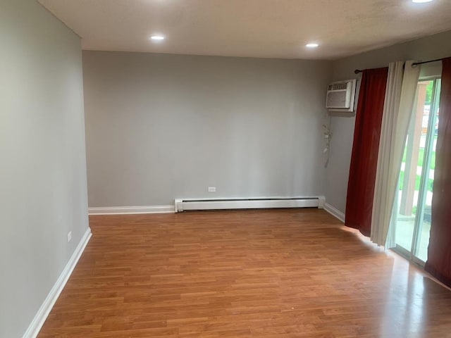 247 N Neltnor Blvd Unit E-1A, West Chicago, IL 60185 - spare room with a baseboard radiator, a wall mounted air conditioner, healthy amount of natural light, light wood-type flooring, and recessed lighting