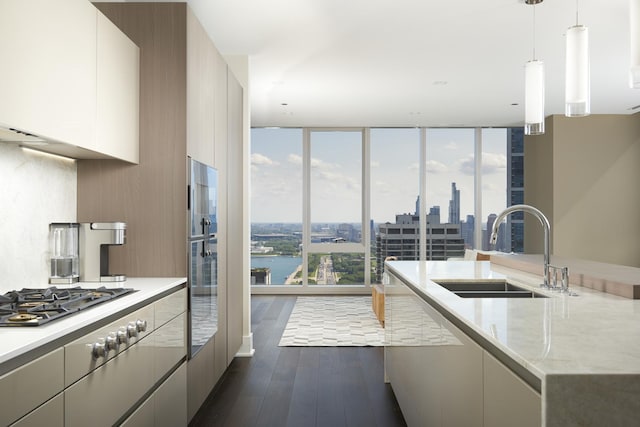 363 E Wacker Dr Unit 3303, Chicago, IL 60601 - kitchen featuring dark wood-style flooring, a wall of windows, modern cabinets, hanging light fixtures, and stainless steel gas cooktop
