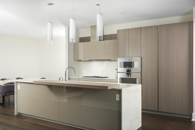 363 E Wacker Dr Unit 3303, Chicago, IL 60601 - kitchen featuring dark wood finished floors, an island with sink, gas stovetop, and modern cabinets