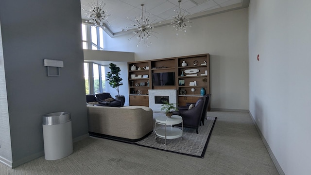 1211 S Prairie Ave Unit 2904, Chicago, IL 60605 - carpeted living area with a towering ceiling, a fireplace, a chandelier, and plenty of natural light