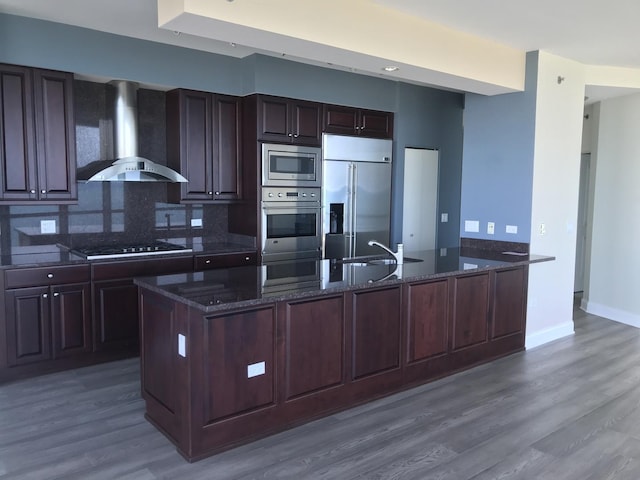 1211 S Prairie Ave Unit 2904, Chicago, IL 60605 - kitchen with built in appliances, wall chimney range hood, dark stone counters, and dark wood-style floors