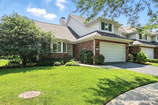 32756 N Stone Manor Dr, Grayslake, IL 60030 - view of front facade with brick siding, concrete driveway, a garage, a front yard, and a chimney