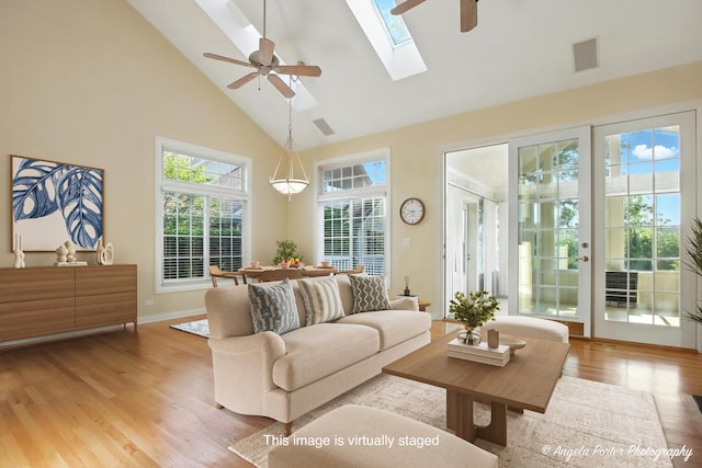 32756 N Stone Manor Dr, Grayslake, IL 60030 - living room featuring high vaulted ceiling, ceiling fan, light wood-style floors, and a skylight