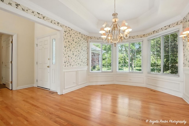 32756 N Stone Manor Dr, Grayslake, IL 60030 - unfurnished dining area with a chandelier, healthy amount of natural light, light wood-style flooring, crown molding, and a wainscoted wall