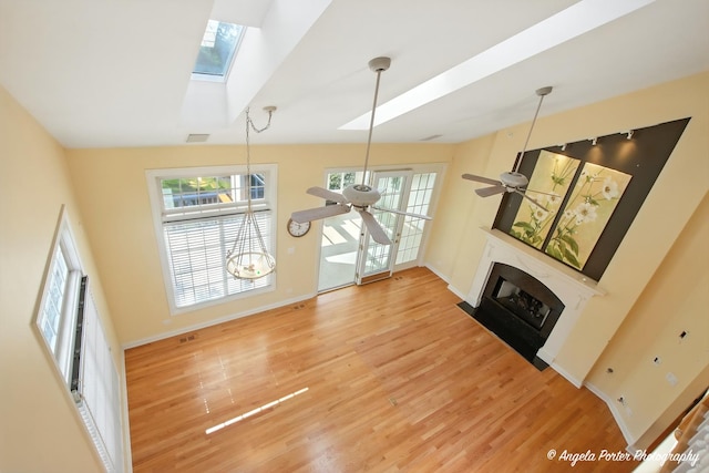 32756 N Stone Manor Dr, Grayslake, IL 60030 - unfurnished living room with ceiling fan, plenty of natural light, light wood-type flooring, and a fireplace