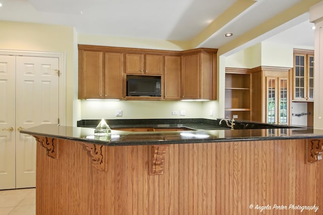 32756 N Stone Manor Dr, Grayslake, IL 60030 - kitchen with black microwave, a kitchen bar, dark stone countertops, a peninsula, and recessed lighting