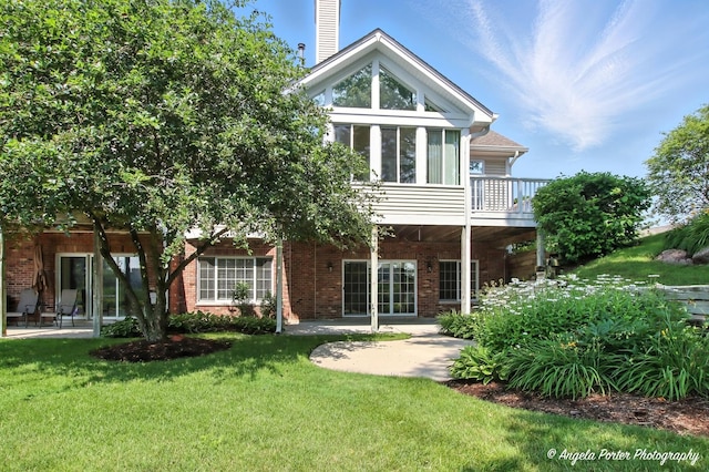 32756 N Stone Manor Dr, Grayslake, IL 60030 - back of property featuring a lawn, a patio, a chimney, and brick siding