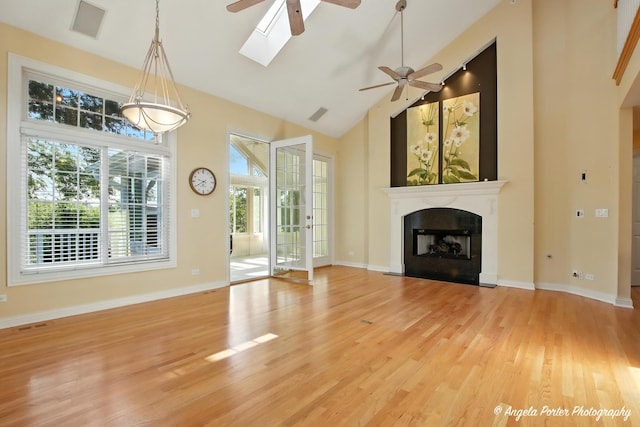 32756 N Stone Manor Dr, Grayslake, IL 60030 - unfurnished living room featuring a ceiling fan, light wood-type flooring, high vaulted ceiling, a skylight, and a fireplace