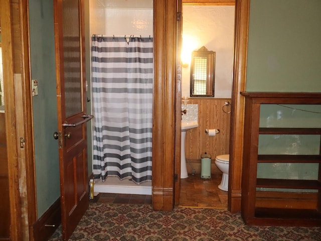303 N Walnut St, Wenona, IL 61377 - bathroom featuring curtained shower, wood walls, and wainscoting