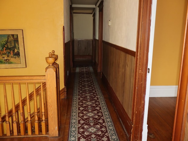 303 N Walnut St, Wenona, IL 61377 - hall with wainscoting, wood finished floors, an upstairs landing, and wood walls