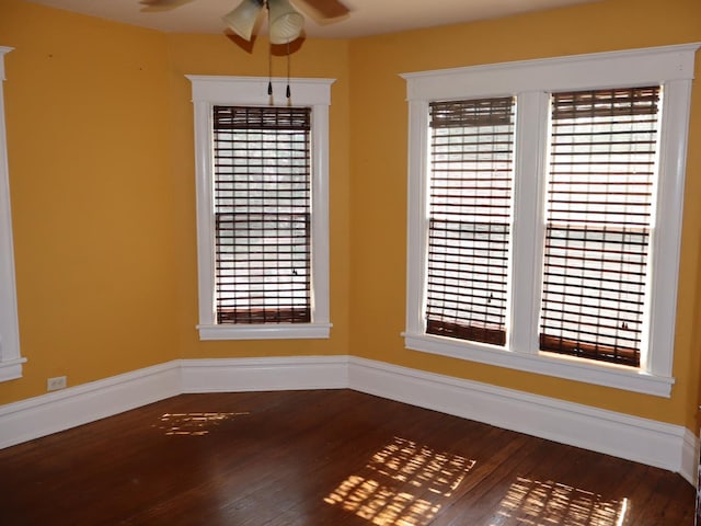 303 N Walnut St, Wenona, IL 61377 - unfurnished room with a ceiling fan, dark wood-type flooring, and healthy amount of natural light