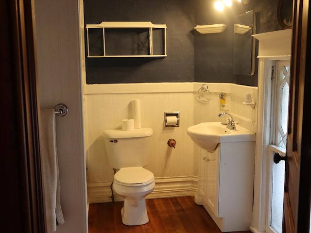 303 N Walnut St, Wenona, IL 61377 - bathroom with wainscoting, wood finished floors, and vanity