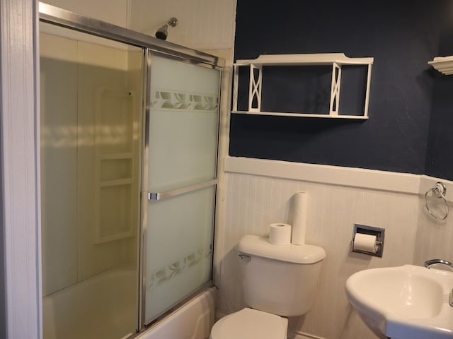 303 N Walnut St, Wenona, IL 61377 - bathroom with a wainscoted wall and combined bath / shower with glass door