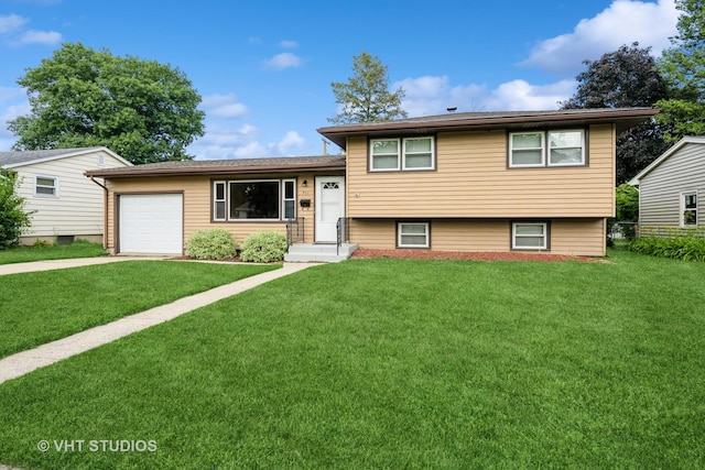 401 Elden Dr, Cary, IL 60013 - tri-level home with concrete driveway, an attached garage, and a front lawn