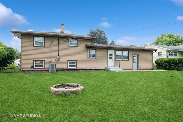 401 Elden Dr, Cary, IL 60013 - back of property featuring a chimney, a yard, and an outdoor fire pit