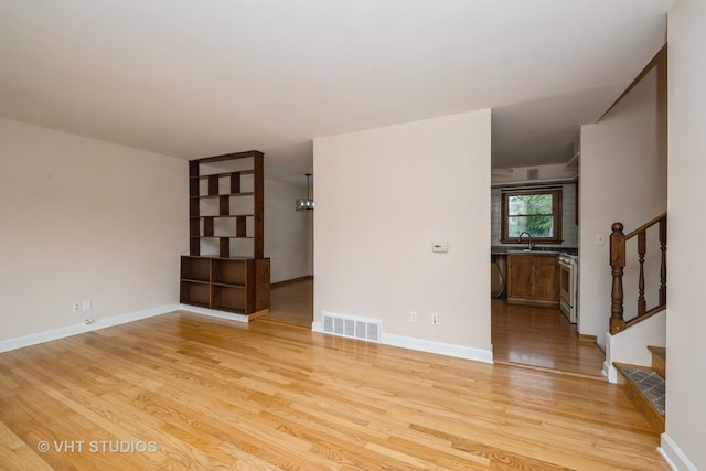 401 Elden Dr, Cary, IL 60013 - empty room with light wood-style floors and stairway