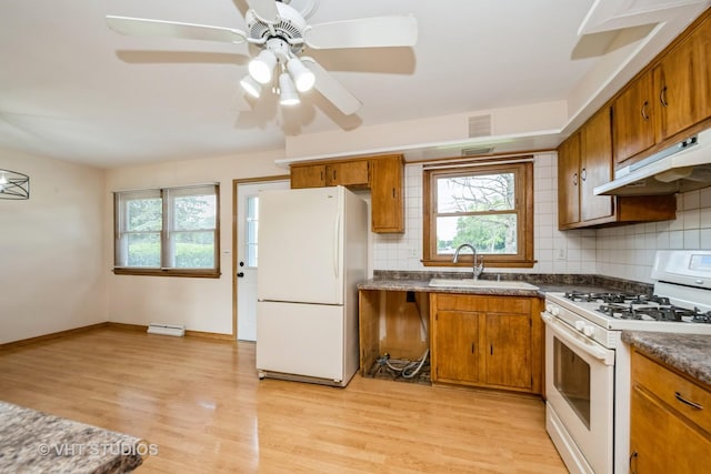 401 Elden Dr, Cary, IL 60013 - kitchen featuring white appliances, plenty of natural light, brown cabinets, and backsplash
