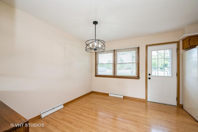 401 Elden Dr, Cary, IL 60013 - unfurnished dining area featuring a baseboard heating unit, light wood-style floors, and a chandelier
