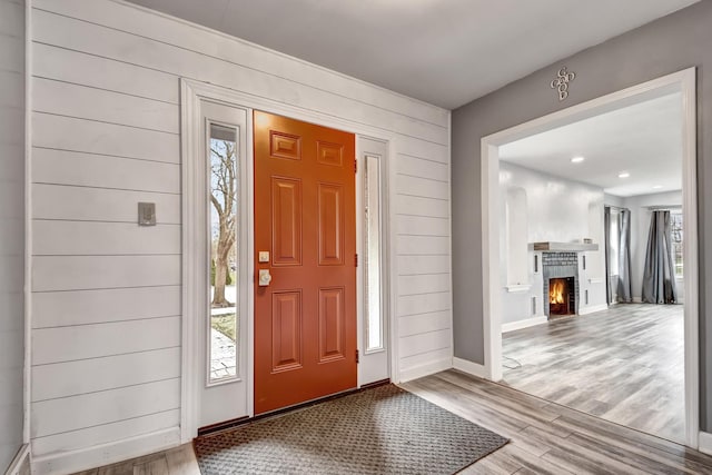 2425 Flossmoor Rd, Flossmoor, IL 60422 - entryway with wood finished floors, a lit fireplace, wood walls, and recessed lighting