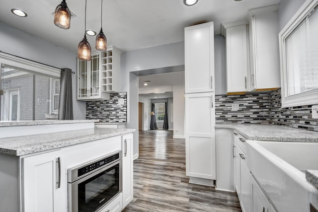 2425 Flossmoor Rd, Flossmoor, IL 60422 - kitchen with decorative backsplash, wood finished floors, white cabinets, glass insert cabinets, and recessed lighting